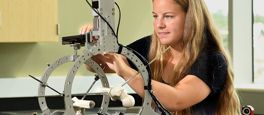 Female student working on osteopathic mechanical device